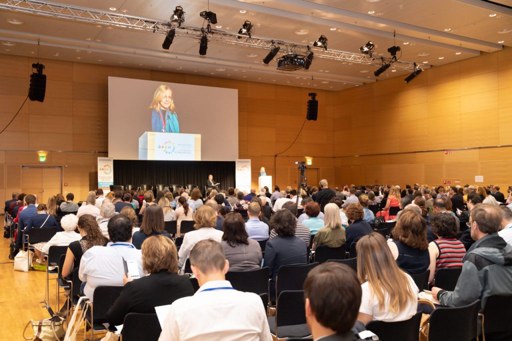 The large conference hall at ECRD 2018 while a woman gives a presentation to the audience