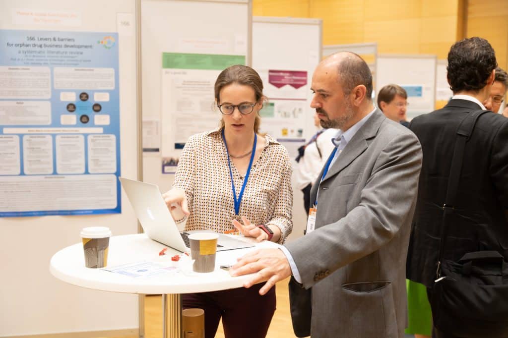 Two people discussing what they see on a computer screen at ECRD 2018